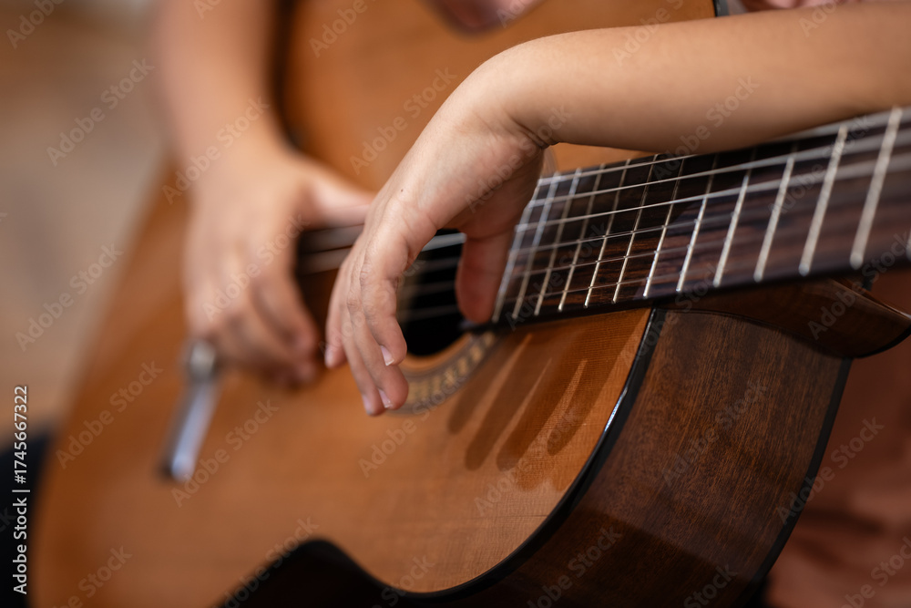 Fototapeta premium Hands playing acoustic guitar strings close up