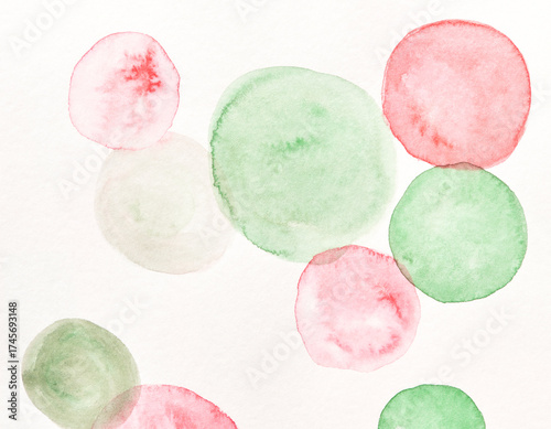 Watercolor abstract circles in green and pink on white background.