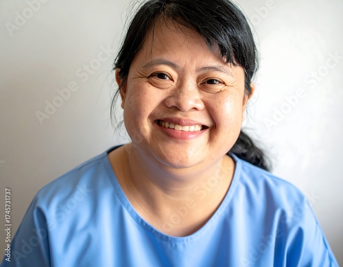 Portrait of a smiling Asian woman in a blue top