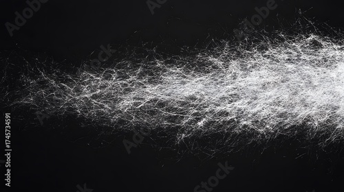 White fluffy fibers appear like a cloud against a dark background.