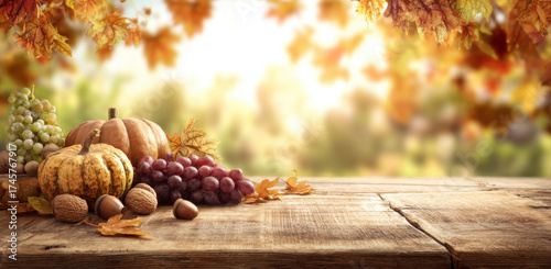 Autumn harvest still life with pumpkins grapes and nuts on a rustic wooden table seasonal background with fall foliage