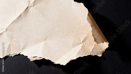 Crumbled brown paper on black background
