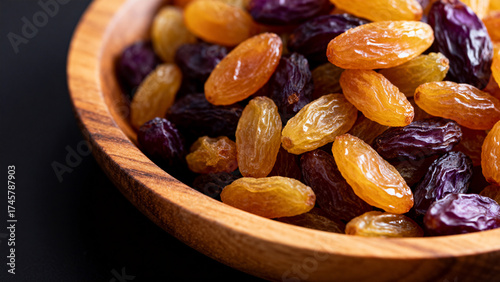 Mixed dried grapes in wooden bowl