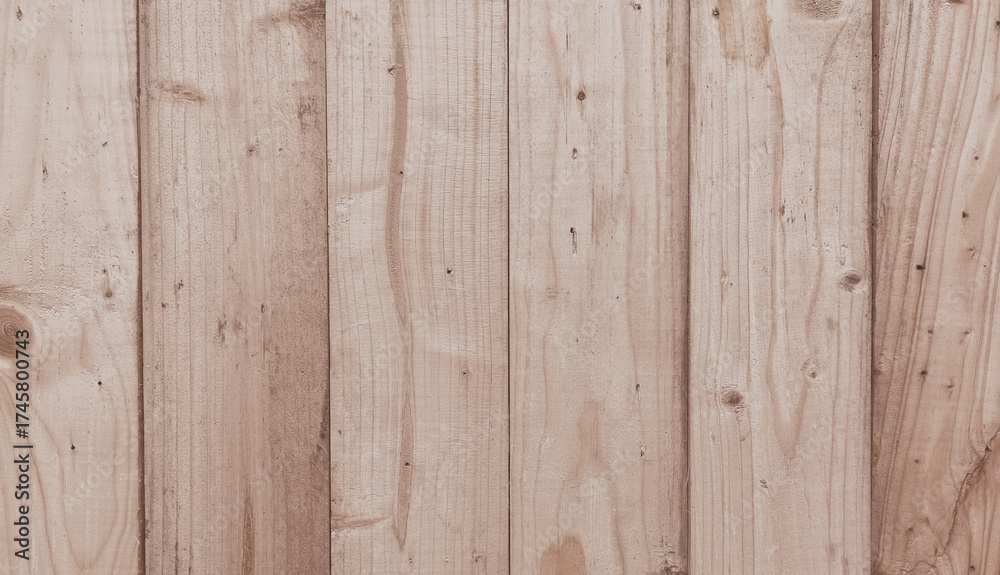 Naklejka premium Wooden fence with light brown vertical planks. Suitable for background elements, texture patterns, rustic or outdoor aesthetic designs.