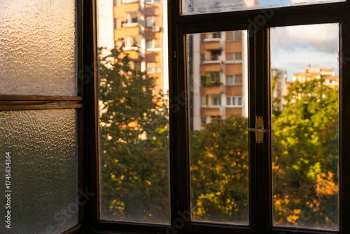 A scenic view from a glass-enclosed terrace overlooking Belgrade's historic old town, with charming architecture and tree-lined streets in Dorcol district. Belgrade, Serbia 06.10.2025