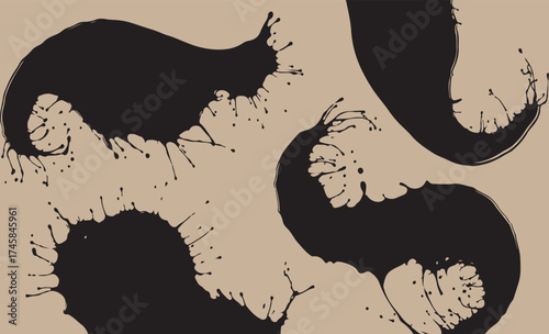 Abstract black ink splatters and splashes on a textured beige background