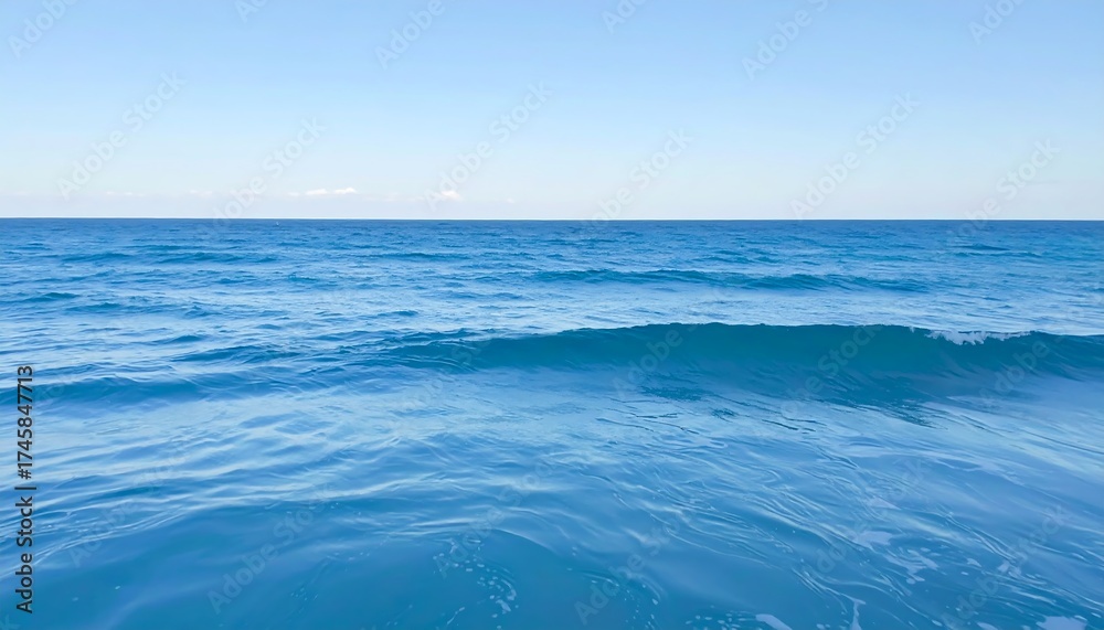 Fototapeta premium Tranquil ocean scene. Vast blue expanse. Gentle waves. Clear sky