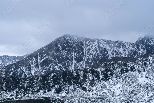 Snow-Capped Mountain Peaks Hidden in Misty Fog