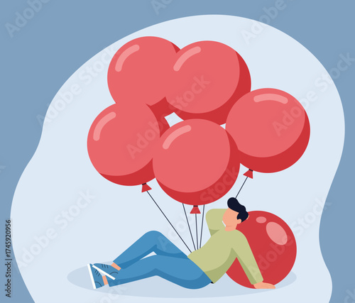 A young man relaxes on the ground, leaning on a red balloon with a large bunch of balloons behind him, representing celebration, dreams, and carefree joy