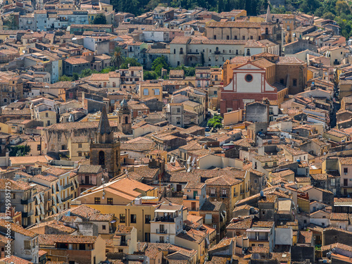 Aerial drone view of Castelbuono medieval town in the Madonie Mountains, Sicily, Italy, basking under the summer sun with historic streets, Ventimiglia Castle. Old mountain town in Sicily