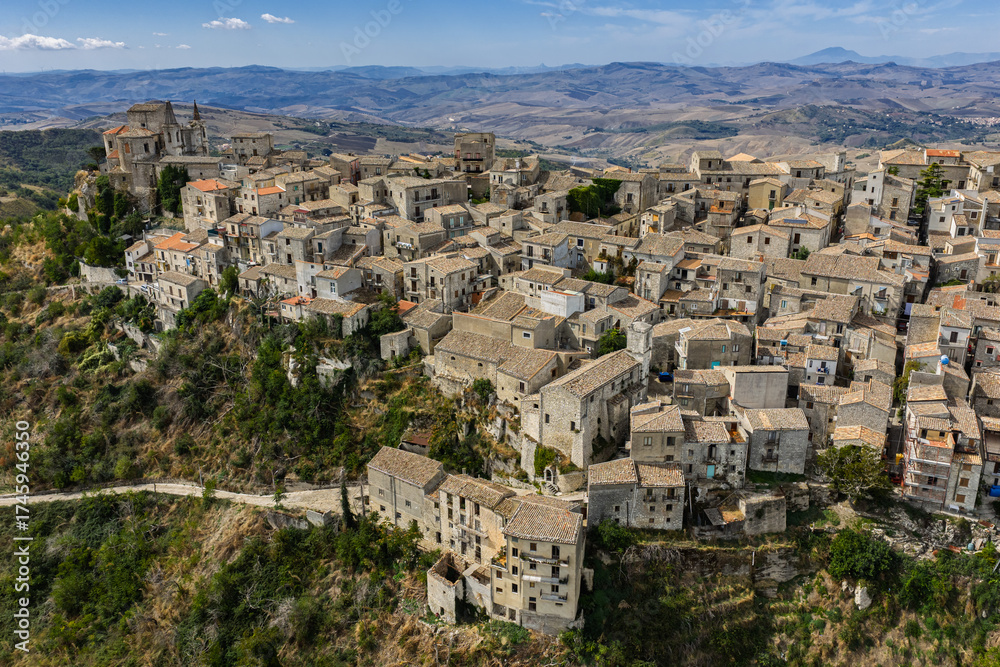 Fototapeta premium Aerial drone view of Petralia Soprana, a historic Sicilian mountain town with panoramic views of the Madonie Mountains,Petralia Soprana famous Church of Saint Mary of Loreto, Sicily, Italy