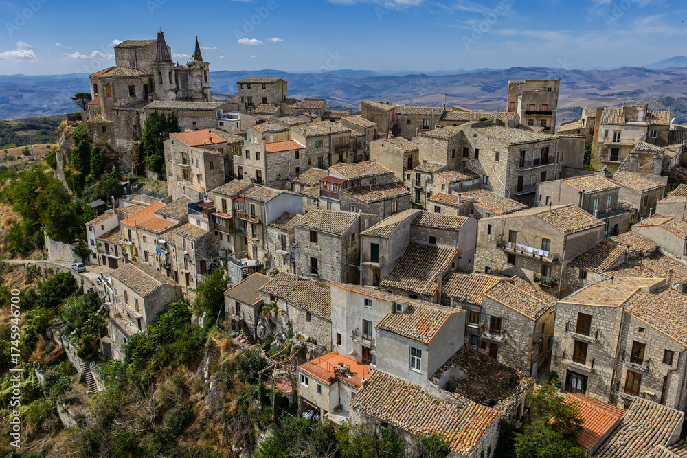Obraz premium Aerial drone view of Petralia Soprana, a historic Sicilian mountain town with panoramic views of the Madonie Mountains,Petralia Soprana famous Church of Saint Mary of Loreto, Sicily, Italy
