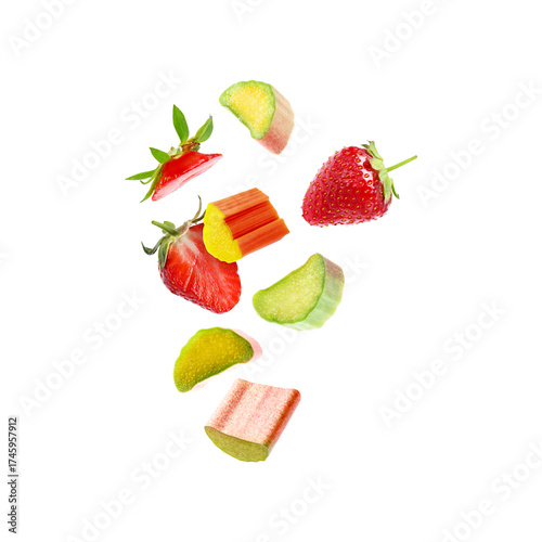 Fresh rhubarb pieces and strawberries flying in air against white background