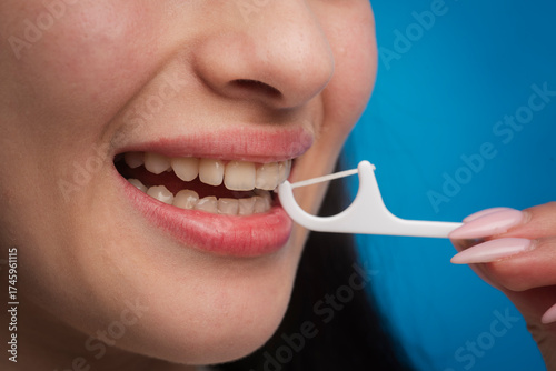 Dental clinic. Dental and stomatology concept. Dental hygiene and oral health care concept. Brushing teeth using plastic toothpick with dental floss. Concept of hygiene and oral cavity.
