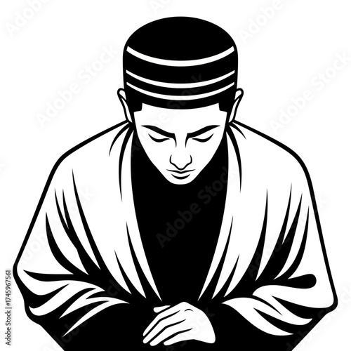 A muslim man wearing a kufi cap and traditional clothing bows his head in prayer or contemplation, isolated on a