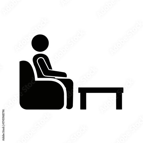 Simple black and white pictogram of a person sitting in a chair next to a table