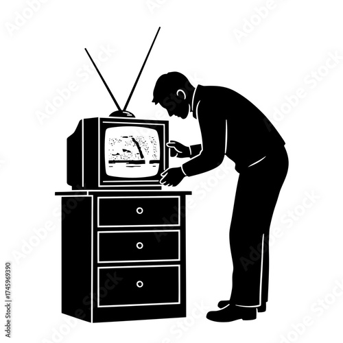 Silhouette of a man adjusting an old television set on a dresser