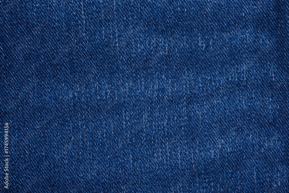 Naklejka premium Washed denim fabric texture background