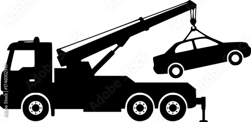 Silhouette of a tow truck lifting a broken down car with its crane
