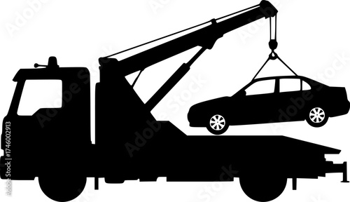 Silhouette of a tow truck lifting a broken down car with its crane
