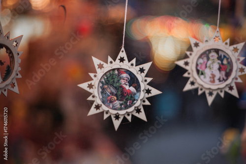Close-up of a wooden handcrafted Christmas decorations  hanging in Chalets, small traditional shops on Christmas Market in Cologne, Germany. Close-up of small gifts with Santa Claus for decoration