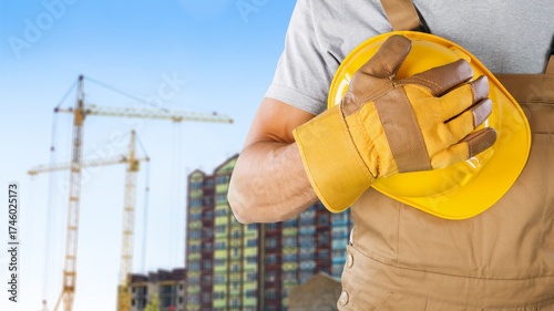 Safety workwear hold safety helmet at construction