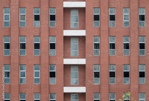 Symmetrical Red Brick Apartment Building Facade with Repetitive Window Pattern