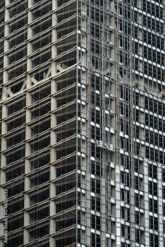 High-Rise Building Under Construction with Scaffolding and Steel Framework