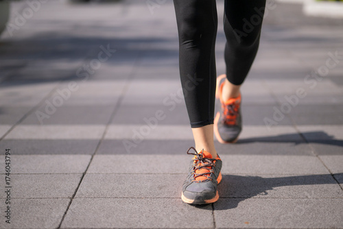 Foto Woman exercising jogging walking on urban sidewalk