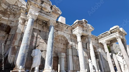 Burdur, Turkey: Tilt down footage of a statue at the Antonine Nymphaeum, a fountain located in the upper agora of Sagalassos archeological site in Turkey during sunny day