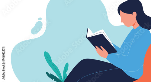 A person quietly reads a book while sitting on a couch in a relaxed pose.