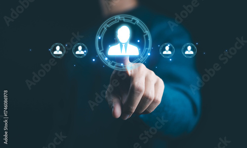 Businessman hand touching virtual HR interface for employee management and recruitment technology. Concept of digital human resources, hiring system, and online networking in modern business.