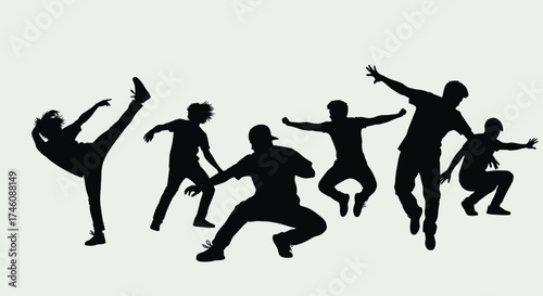 Silhouetted figures performing dynamic dance moves, showcasing energetic choreography and movement.