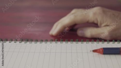 Woman's hand tapping on work desk