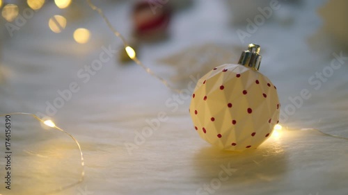 Christmas ball on white wool with lights for xmas concept.