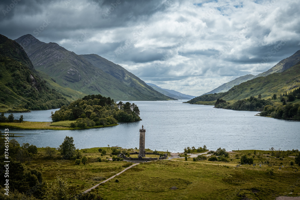 Fototapeta premium Scenic View of Glenfinnan Monument and Loch Shiel under Cloudy Sky in the Scottish Highlands - Scotland