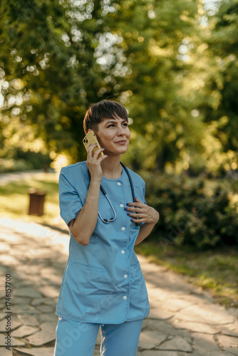 Healthcare worker talking on phone outdoors during break