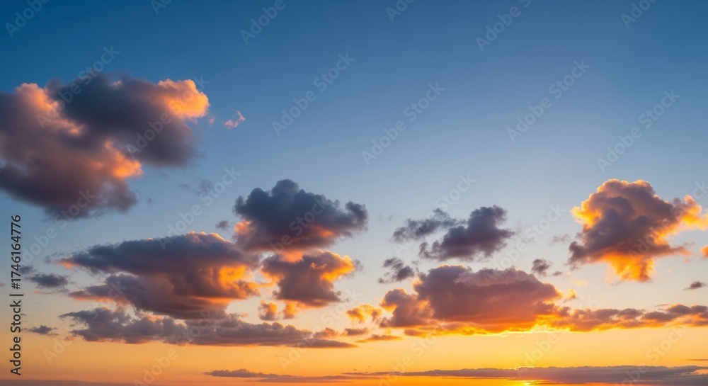 Fototapeta premium Stunning sunset sky with dramatic clouds in vibrant hues. The backlit clouds create a breathtaking natural display against the clear blue sky, evoking feelings of tranquility and inspiration.