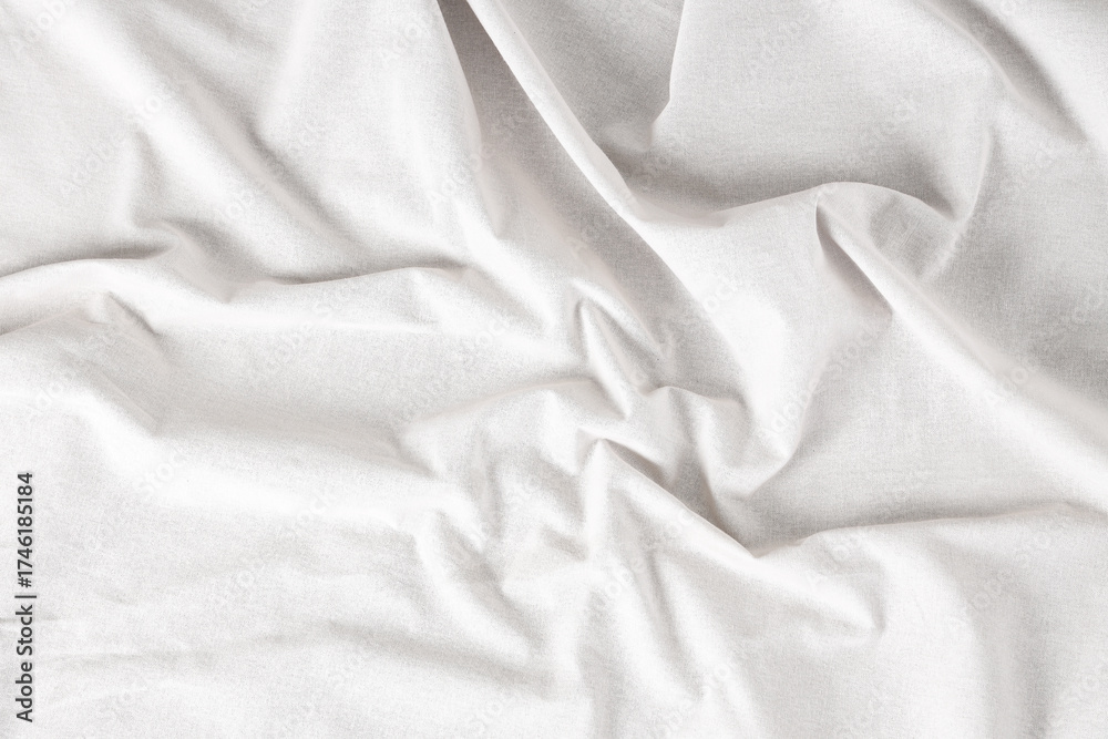 Obraz premium Crumpled white tablecloth as background, top view