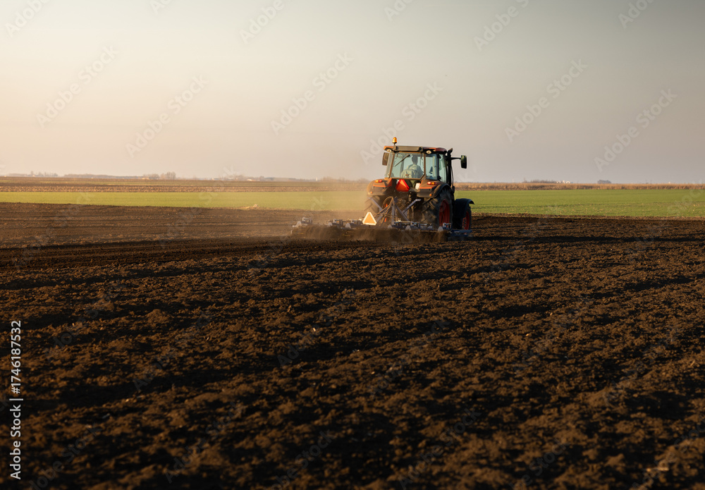 Fototapeta premium Tractor preparing the land for a new crop planting