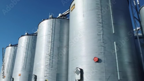 Grain Silos Under Blue Sky A Close-Up Look at Agriculture