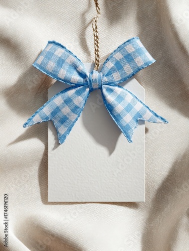 Blank Tag with Gingham Bow: A pristine white gift tag is adorned with a charming gingham bow in a gentle, inviting composition of gift giving.