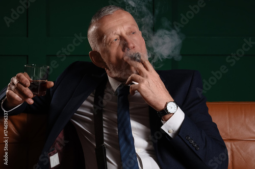 Old businessman with glass ...