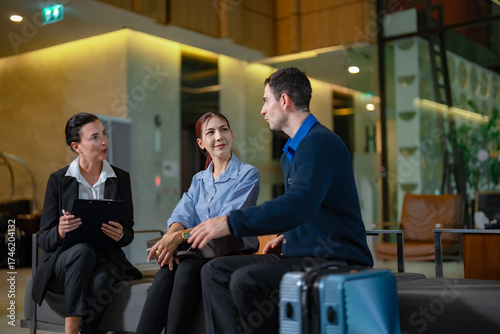 Concierge assisting guests with check-in, visa requirements, and payment process in modern hotel environment, concept of service excellence. Business travel and service lifetyle.