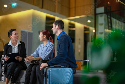 Front desk staff talking to travelers about hotel promotions, travel insurance, and special packages, concept of global hospitality. Business travel and service lifetyle.