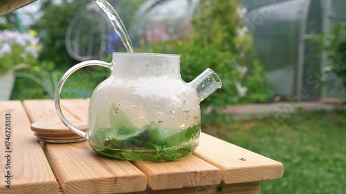 Mint and lemon balm green tea is brewed in an outdoor kettle