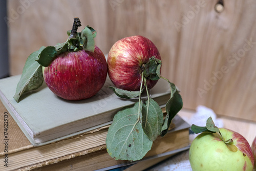 Ripe apples on a stack of books. Autumn background with apples.