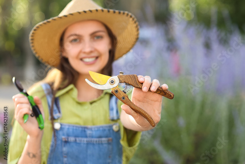 Young female gardener with ...
