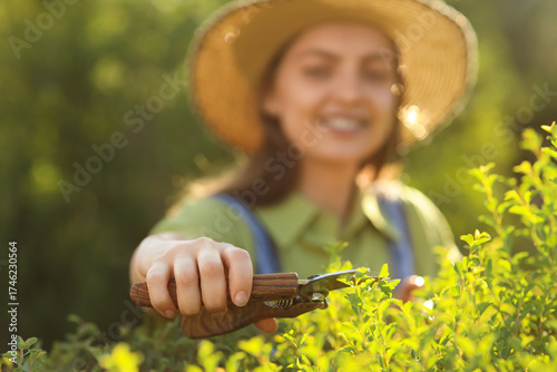 Young female gardener with ...