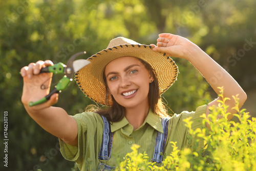 Young female gardener with ...